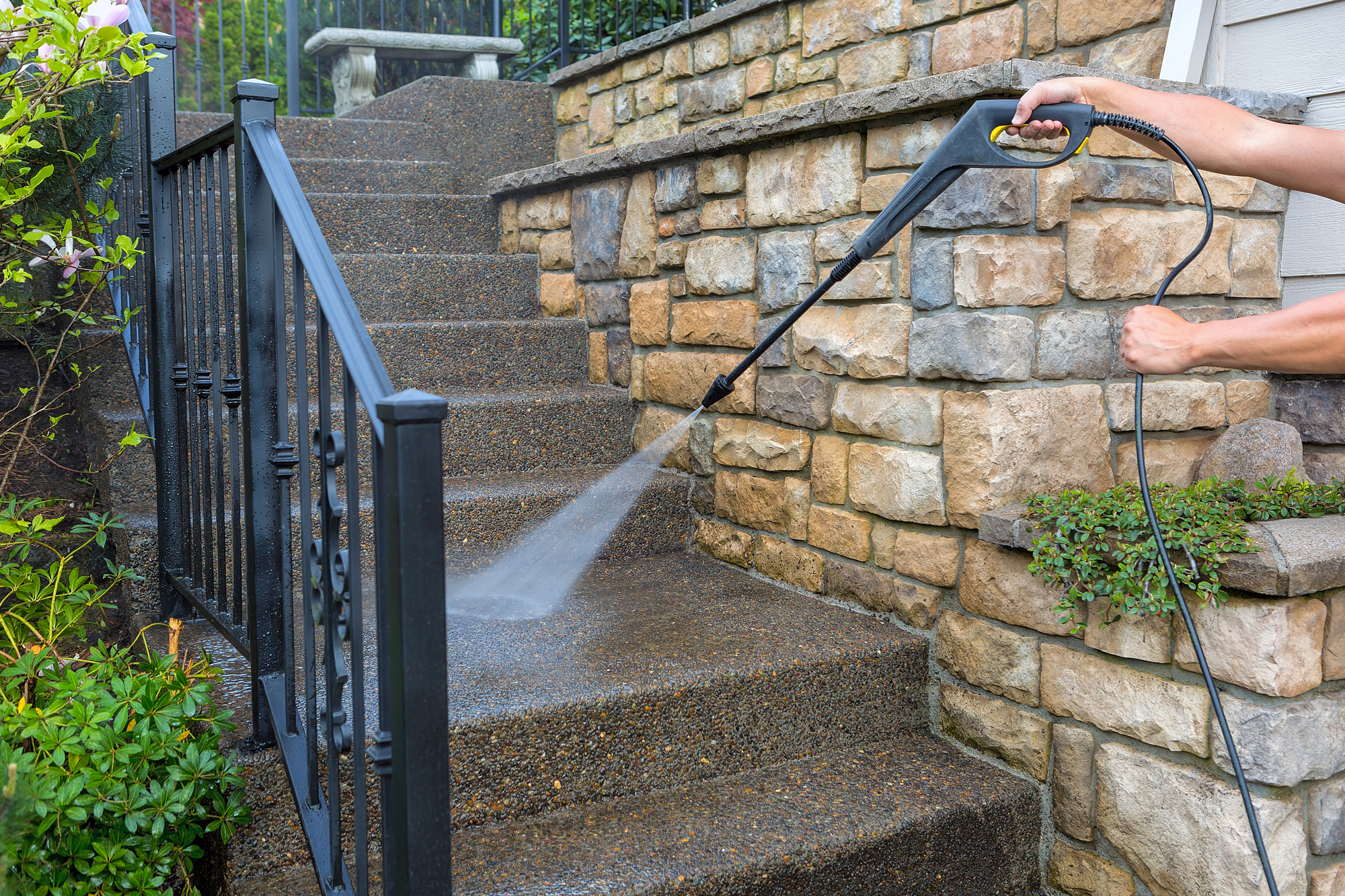 A man cleans the steps of a house
